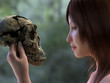 young woman is holding a skull of a prehistoric man