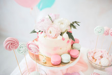 Pink Cake With Fresh Flowers. White Wedding Cake. Colored Cupcakes And Macaroni.