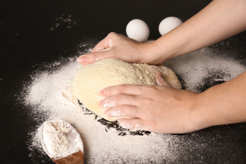 Wall Mural - Woman kneading dough on kitchen table