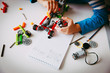 little boy building robot at robotic technology school lesson