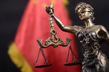 Wall Mural - Scales of Justice, Justitia, Lady Justice in front of the flag of China in the background.