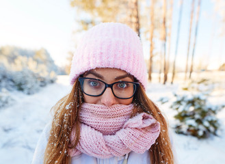 Wall Mural - girl in glasses in the frost in snowflakes.