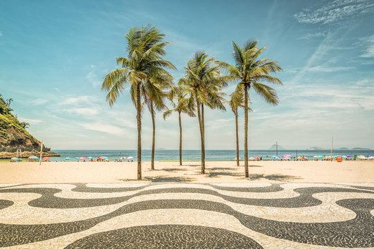 palms on copacabana beach and landmark mosaic in rio de janeiro, brazil