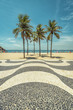 Palms on Copacabana Beach with famous mosaic boardwalk in Rio de Janeiro, Brazil