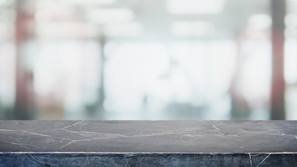 Empty black stone marble table top and blurred abstract background from interior office building background - can used for display or montage your products.