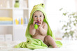© Oksana Kuzmina - Baby boy with green towel after the bath biting toy