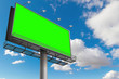 empty billboard with chroma key green screen, on blue sky with clouds, advertisement concept