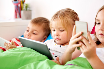 Poster - little kids with tablet pc in bed at home