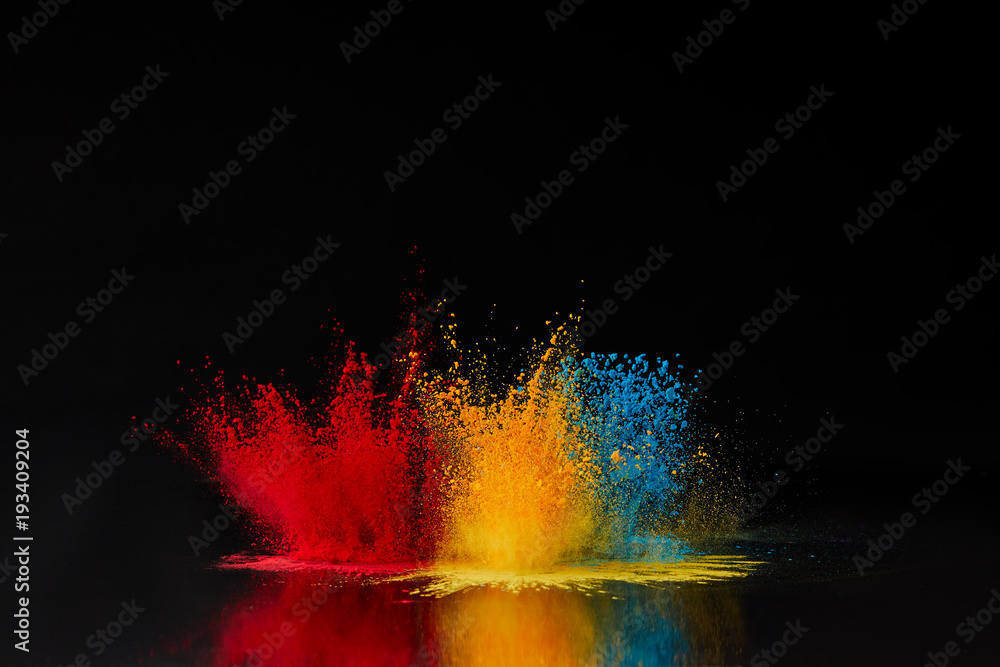 red, blue and yellow holi powder explosion on black, Hindu spring festival - obrazy, fototapety, plakaty 