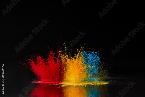 Fotomural red, blue and yellow holi powder explosion on black, Hindu spring festival