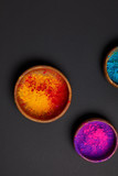 Fototapeta Mapy - top view of colorful holi powder in bowls on grey surface, Hindu spring festival