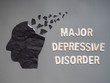 Depression or Major Depressive Disorder (MDD) presented by human head made form black crumpled paper torn on gray background. Mental health care, brain disorder and psychology concept.