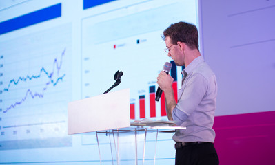 Fototapete - Business Presentation. Presenter Showing Charts and Graphs.