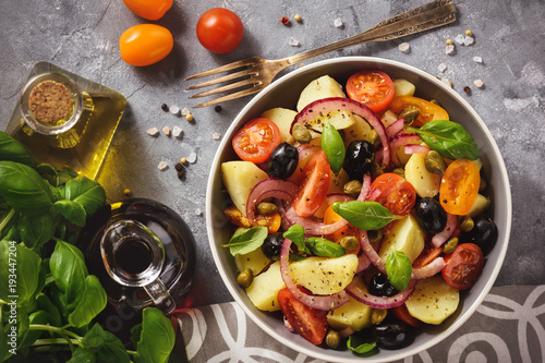 Fotomural Potato salad with tomatoes, olives, capers, red onion, italian style cuisine
