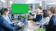 © Gorodenkoff - Diverse Group of Successful Business People in the Conference Room with  Green Screen Chroma Key TV on the Wall. They Work on a Company's Growth, Share Charts and Statistics.