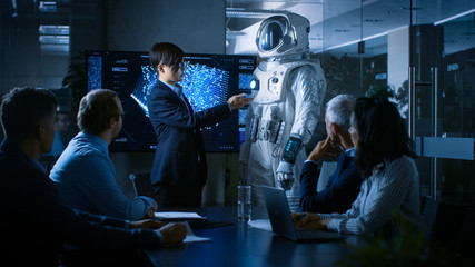 In the Conference Room Chief Engineer Presents Next Generation Space Suit to a Board of Directors. Completely Original Design with Integrated AI and Neural Network Systems. New Level of Space Travel.