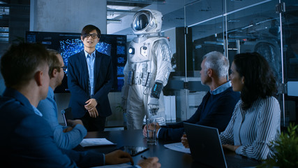 Poster - In the Conference Room of the Center of Technology Chief Engineer Presents Next Generation Space Suit to a Board of Directors. Completely Original Design with Integrated AI and Neural Network Systems.