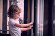 © ADDICTIVE STOCK - Little boy standing on balcony