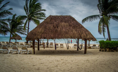 Four hanging hammocks at the beach