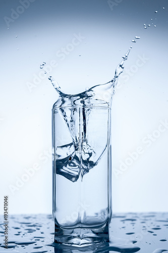 Splash Of Water In Glass Cup With Ice Slice On White Background Close Up Stock Photo Adobe Stock Splash Of Water In Glass Cup With Ice Slice On White Background Close Up Stock Photo Adobe Stock