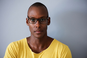 Wall Mural - handsome african american man with glasses against gray background