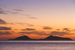 View of Trikeri island against colorful morning sky from Spetses, Greece. 