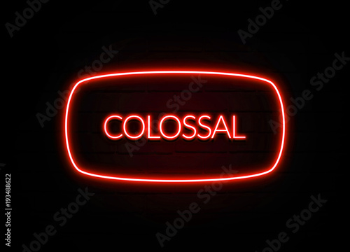 Fotografia  Colossal neon sign on brick wall background.