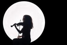 Silhouette Of A Girl In A White Circle With A Violin In Her Hands. Concept. Music For The Full Moon. Night Background. Copy Space.
