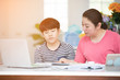 © sirikorn - Asian boy with mother teaching and learning your homework at home