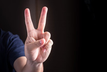 Hand With Two Fingers Up. Sigh Of Peace Or Victory. Also The Sign For The Letter V In Sign Language. Studio Lights