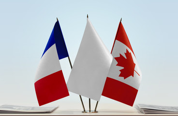 Flags of France and Canada with a white flag in the middle