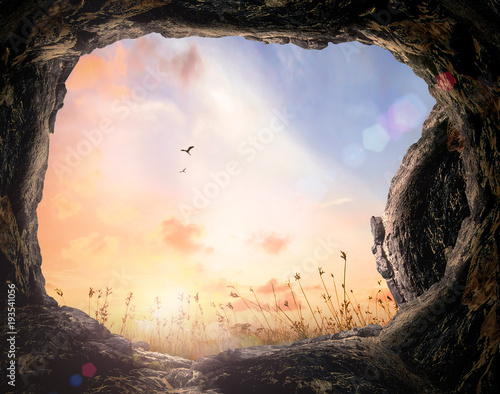 Fotomural Resurrection of Easter Sunday concept: Tomb stone and meadow autumn sunrise back