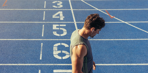 Wall Mural - sprinter standing on running track