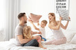 © Africa Studio - Happy family having pillow fight in bed at home