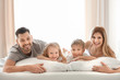 © Africa Studio - Happy family on bed with soft pillows at home