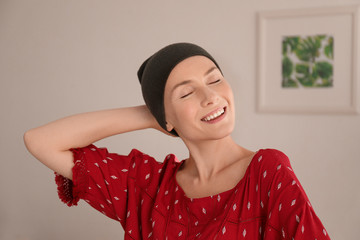 Wall Mural - Young woman with cancer in hat indoors