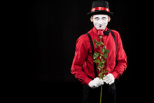 Mime Sniffing Red Rose With Closed Eyes Isolated On Black