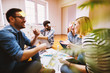 © Dusan Petkovic - Group of excited and confident young people sitting in a row in the waiting room with a folder in hand before an interview with the entrepreneur and sharing personal details.