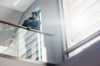 © Jacob Lund - Businessman in office corridor talking on cell phone
