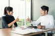 © ake1150 - Asian business team partner in business office  thump up after successful business deal.