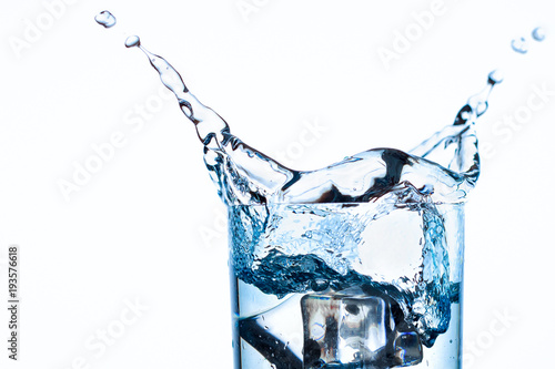 Splash Of Water In Glass Cup With Ice Slice On White Background Close Up Stock Photo Adobe Stock