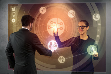 Man and woman at work of the team company operating a virtual touchpad and hologram in the near future