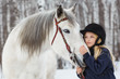 Little girl with a white horse, outdoor