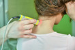 © dobok - Laser therapy. Physical therapist treating patient neck