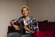 © ADDICTIVE STOCK - Cheerful ethnic man with guitar