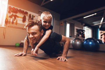 Father and son in the gym. Father and son spend time together and lead a healthy lifestyle.