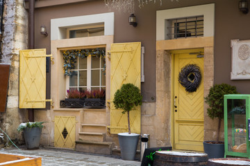 Beautiful antuque european old city exterior with yellow design elenments and decorations, vintage doors ans street lights  postcard concepr