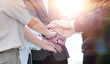 © ASDF - business colleagues with their hands stacked together