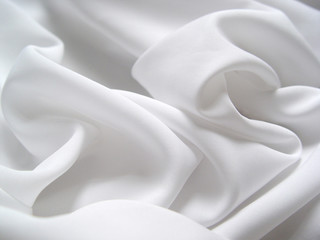 white satin fabric draped in soft waves