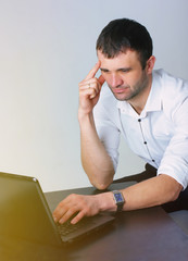 Wall Mural - Successful man working on laptop. Confident businessman. White background